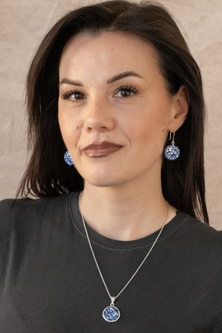 Sterling silver Celest necklace with marbled blue stone pendant worn by model in black top by Nile & Nova