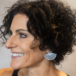 Model wearing Nile & Nova’s Soleil earrings — sculptural sterling silver fans that catch the light beautifully.